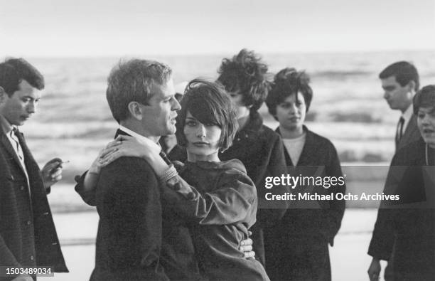 Actors Klaus Kinski and Ruth Brigitte Tocki pose for a portrait on the beach in Ostia in March 1966 in Rome, Italy.