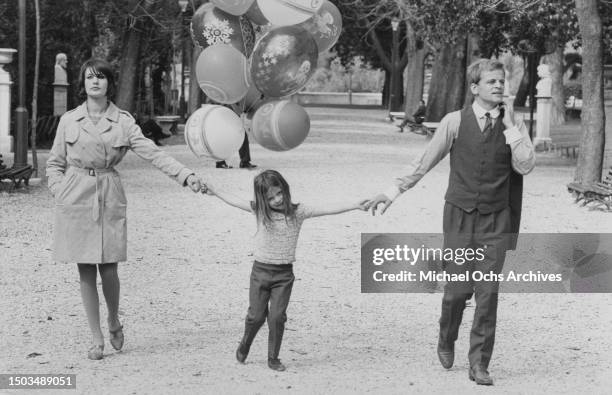 Actors Klaus Kinski and Ruth Brigitte Tocki with their daughter Nastassja Kinski pose for a portrait in a park in March 1966 in Rome, Italy.