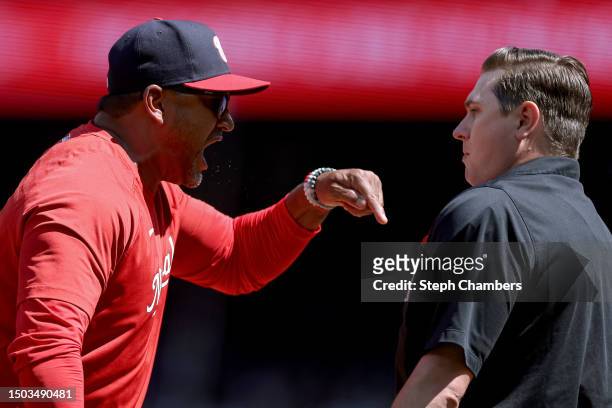 Manager Dave Martinez of the Washington Nationals yells at umpire Derek Thomas after a call at home plate against the Seattle Mariners during the...