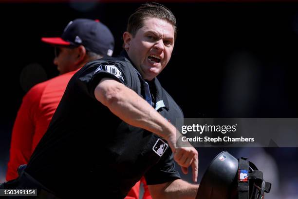 Umpire Derek Thomas throws manager Dave Martinez of the Washington Nationals out of the game against the Seattle Mariners during the sixth inning at...