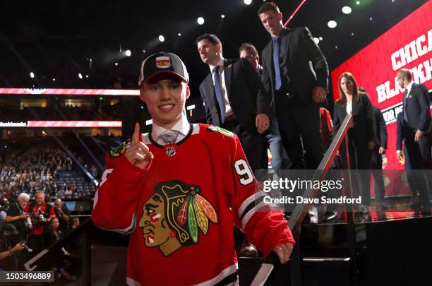 Connor Bedard raises a forefinger after being selected first overall by the Chicago Blackhawks during the 2023 Upper Deck NHL Draft - Round One at...