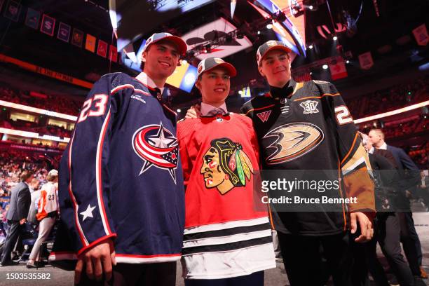 Adam Fantilli of the Columbus Blue Jackets, Connor Bedard of the Chicago Blackhawks and Leo Carlsson of the Anaheim Ducks pose for a photo after...