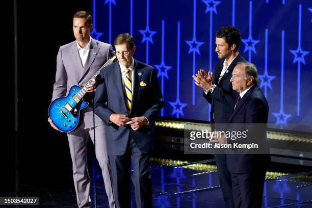 Pekka Rinne, David Poile of the Nashville Predators, NHL commissioner Gary Bettman and Roman Josi are seen on stage during round one of the 2023...