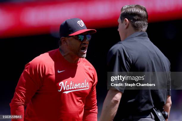 Manager Dave Martinez of the Washington Nationals yells at umpire Derek Thomas after a call at home plate against the Seattle Mariners during the...