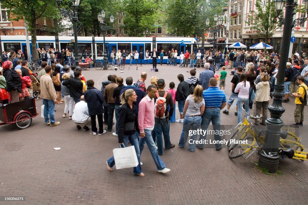 Busker and crowd at Leidseplein in Southern Canal belt.