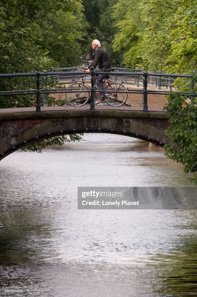 Cyclist riding across bridge over the 'Golden Bend'.