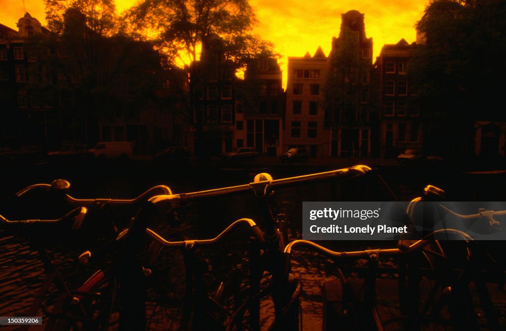 Sunrise over bicycles and buildings - Amsterdam, North Holland