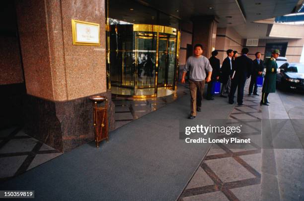 entrance to beijing's st regis hotel in the jianguomenwai embassy area. - jianguomenwai fotografías e imágenes de stock