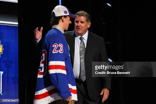 Gabriel Perreault is congratulated by head coach Peter Laviolette after being selected with the 23rd overall pick during round one of the 2023 Upper...