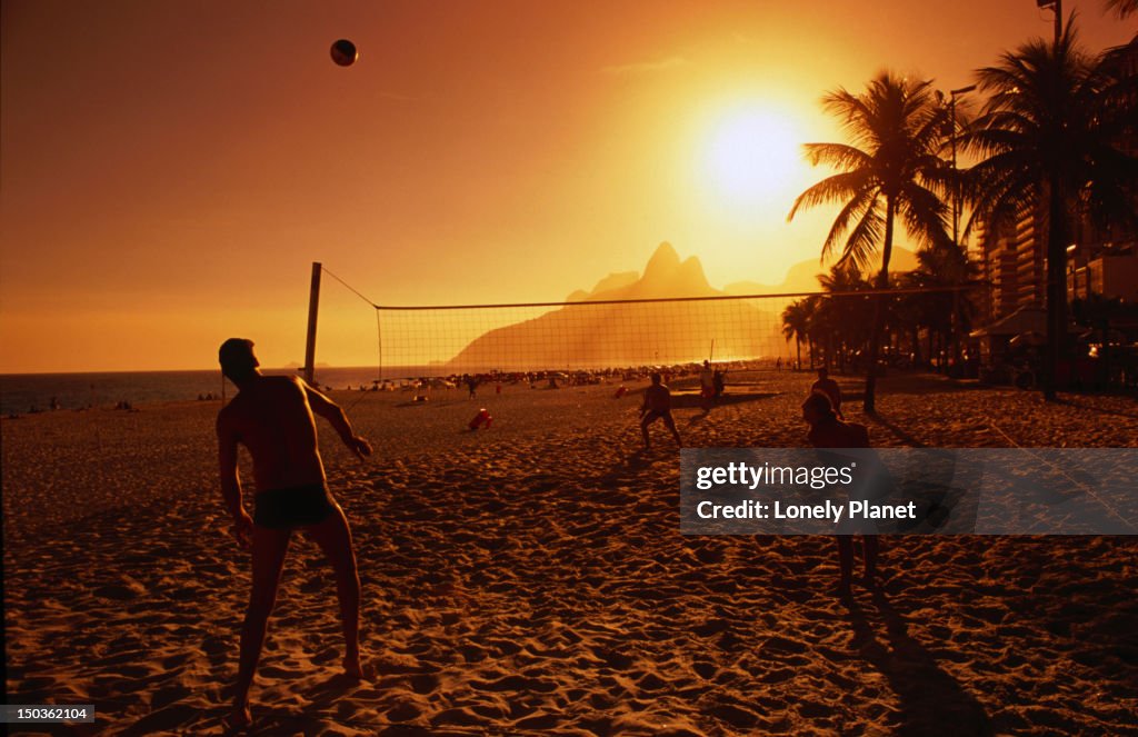 People playing volleyball at Ipanema beach.
