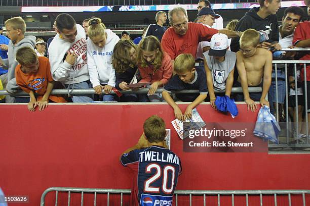 Midfielder Taylor Twellman of the New England Revolution signs autographs for fans during the MLS match against the New York/New Jersey MetroStars on...