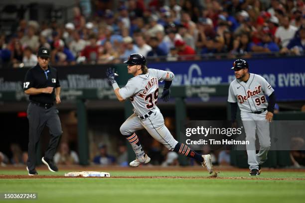 Zach McKinstry of the Detroit Tigers rounds first base on a double in the sixth inning against the Texas Rangers at Globe Life Field on June 28, 2023...