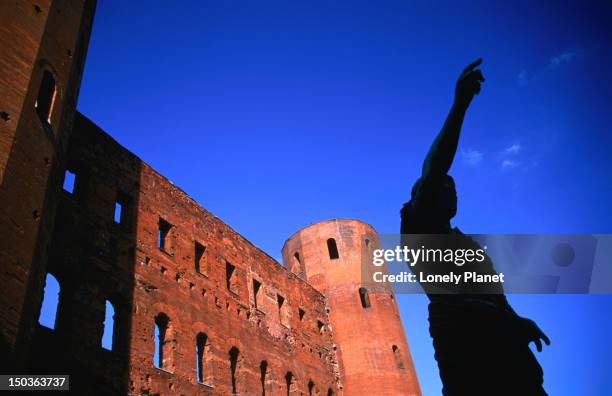 roman statue in front of porta palatina, roman gate. - porta palatina stock pictures, royalty-free photos & images