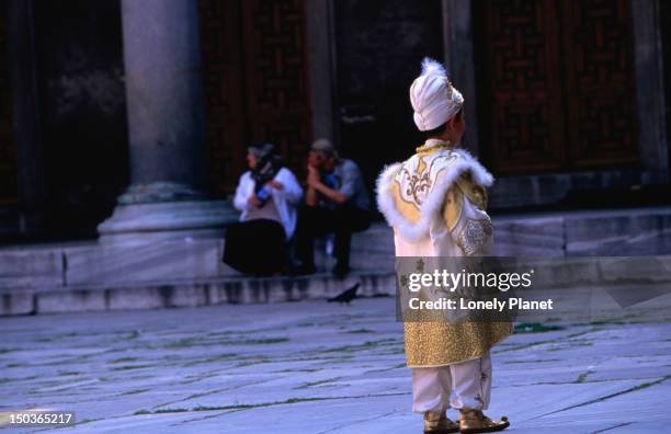 young boy in circumcision finery. - boy circumcision stock pictures, royalty-free photos & images