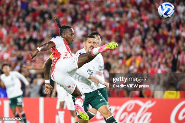 Hugo Rodallega of Santa Fe shoots on target as Hugo of Goias keeps an eye on the ball during the Copa CONMEBOL Sudamericana 2023 group G match...
