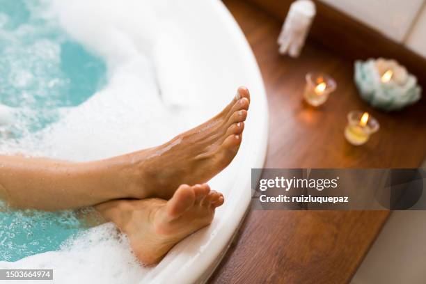 relaxed woman taking a foam bath - bathtub with candles stock pictures, royalty-free photos & images