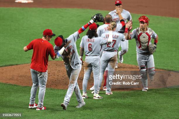Elly De La Cruz of the Cincinnati Reds celebrates with teammates after the Reds defeated the Baltimore Orioles 11-7 in ten innings at Oriole Park at...