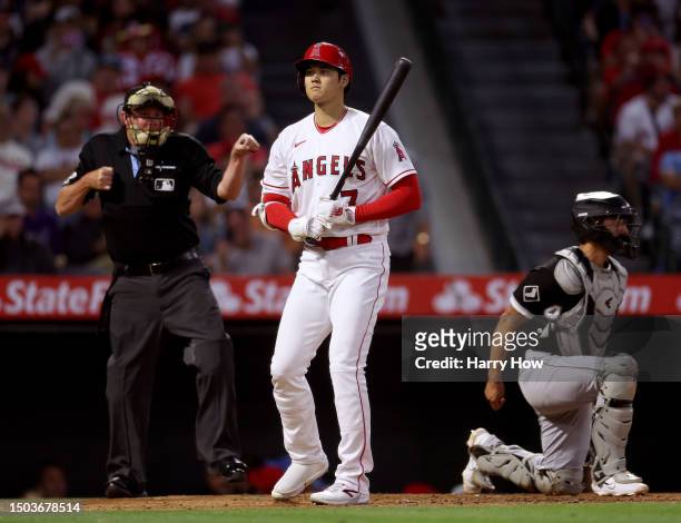 Shohei Ohtani of the Los Angeles Angels reacts as he is called out on strikes next to Seby Zavala of the Chicago White Sox by umpire Chad Whitson...