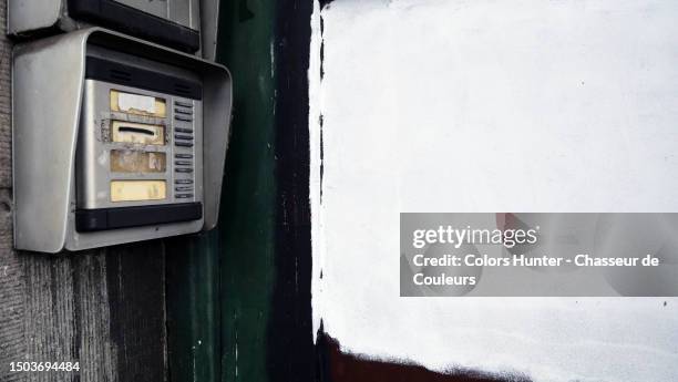 doorbells in front of the front door of an abandoned residential building in brussels, belgium - doorbell stock pictures, royalty-free photos & images