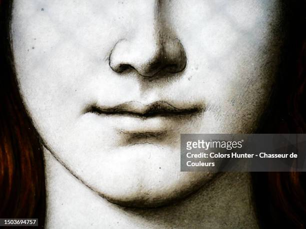 a woman's nose, mouth, cheeks, chin and neck on an old stained glass window in paris, france - stained glass church stock pictures, royalty-free photos & images