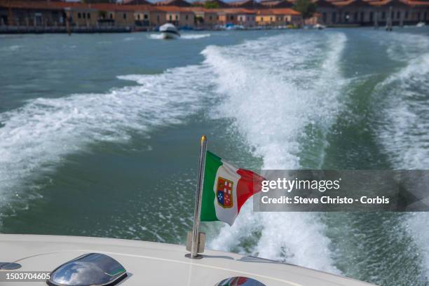 Italian Maritime republic flag on the back of a Vaporetto , on August 17 in Venice, Italy.