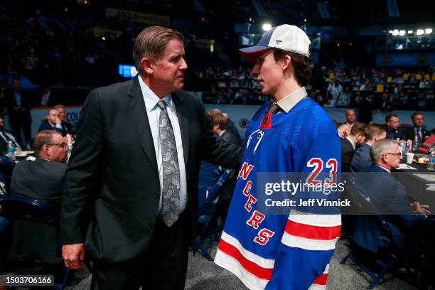 Gabriel Perreault talks with head coach Peter Laviolette after being selected 23rd overall by the New York Rangers during the 2023 Upper Deck NHL...