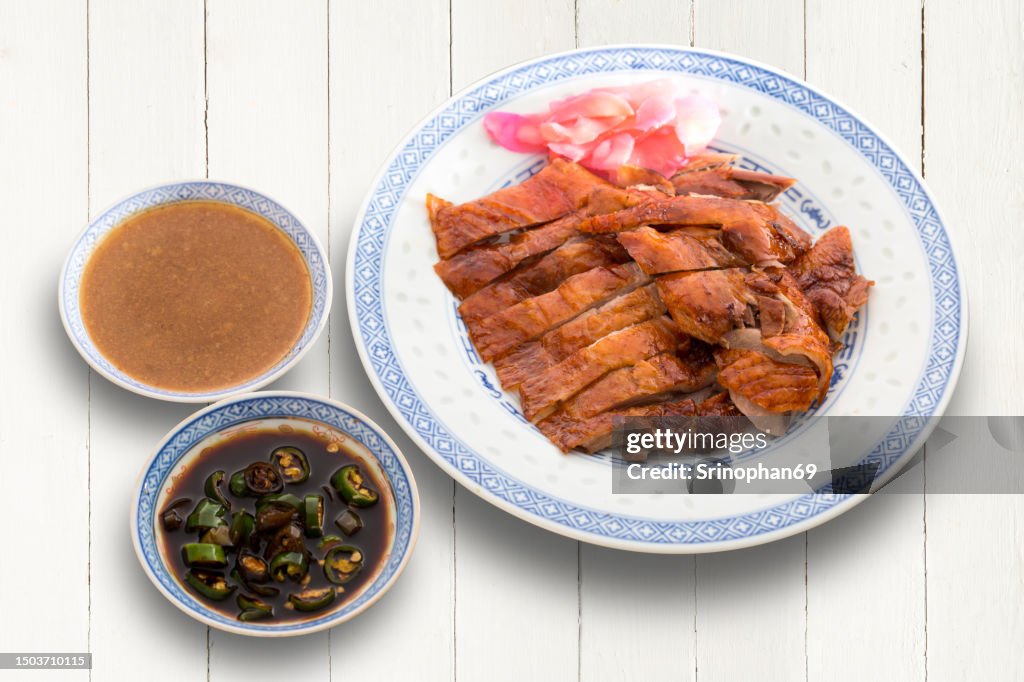 Delicious Peking Roast Duck Chop on Plate with Tempting Dipping Sauce - Exquisite Chinese Cuisine