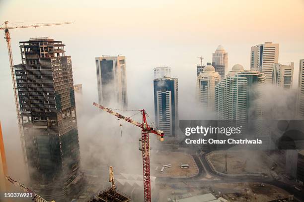 doha in fog - doha skyscraper stock pictures, royalty-free photos & images