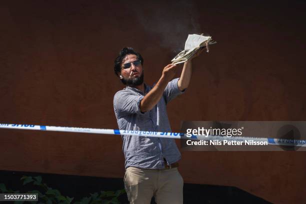 Man burns a koran and covers it with bacon at the Stockholm mosque on June 28, 2023 in Stockholm, Sweden. Whilst Muslims celebrate the most...