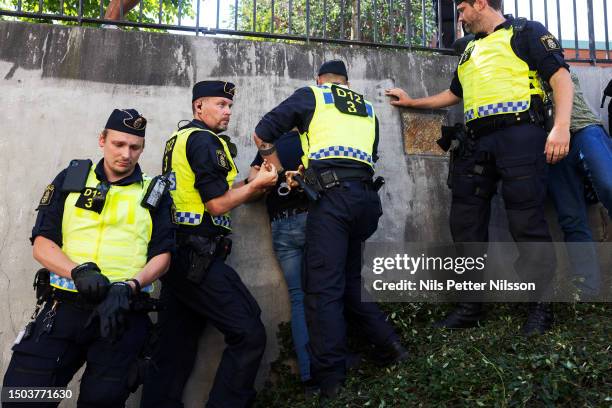 Police arrests a man who threw stones at a protest were a koran was burned at the Stockholm mosque on June 28, 2023 in Stockholm, Sweden. Whilst...