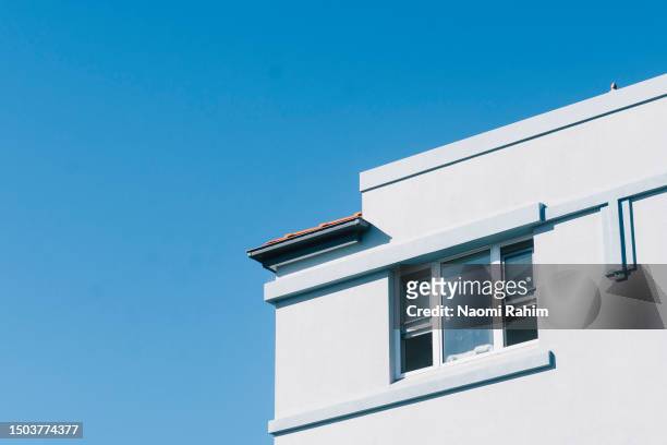 close-up view of a retro blue apartment block with an open window - open house stock-fotos und bilder