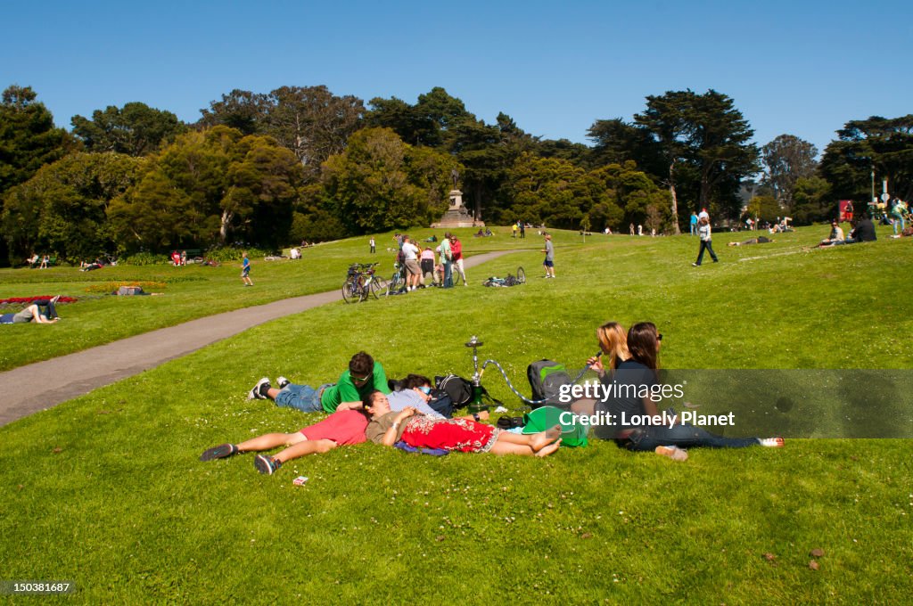 Young people relaxing in grass at Golden Gate Park.