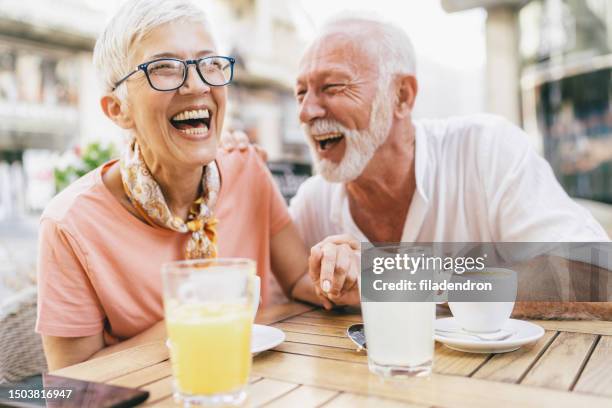 senior couple in sidewalk cafe - 55 year old white male stock pictures, royalty-free photos & images