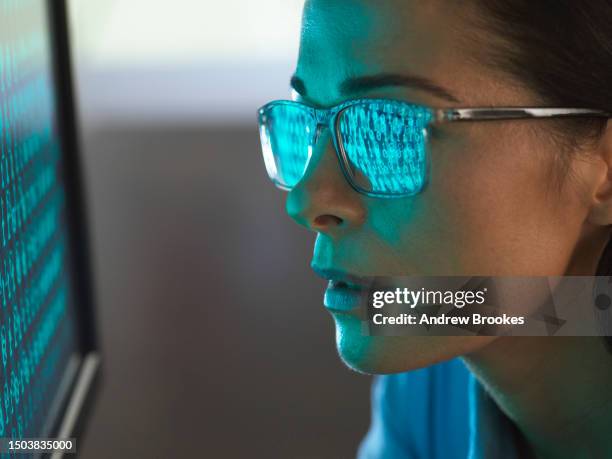 close-up of programmer with binary code reflected in eyeglasses - computer code stock pictures, royalty-free photos & images