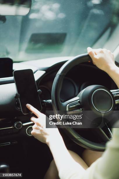 asian woman using smartphone in a car - front passenger seat stock pictures, royalty-free photos & images