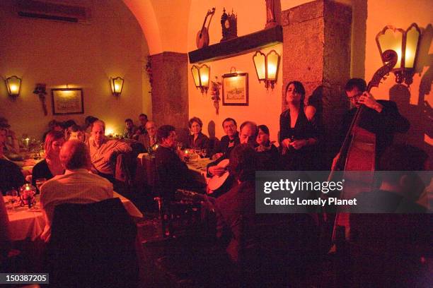 people watching fado performance at clube de fado, alfama. - fado stock-fotos und bilder