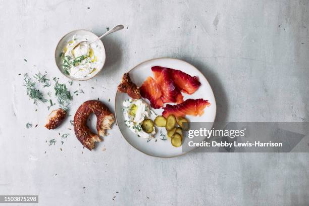 beetroot cured salmon served with dill, pretzel, gherkins and yogurt sauce - dill stock pictures, royalty-free photos & images