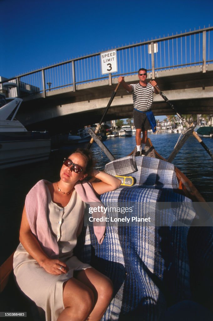 Woman relaxing in afternoon sun on a Gondola Getaway, Naples.