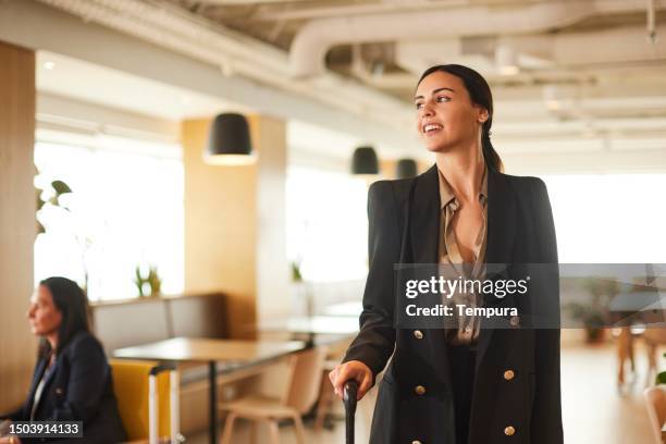 air travel elegance: woman in vip lounge at the airport. - vip lounge stock pictures, royalty-free photos & images