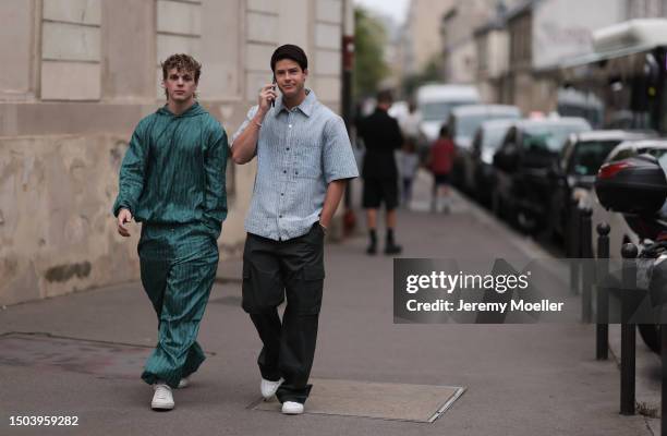 Jack Wright wearing Amiri green matching Jogging set includes longsleeve sweather and wide leg sporty pants with white sneaker. Besides him Blake...