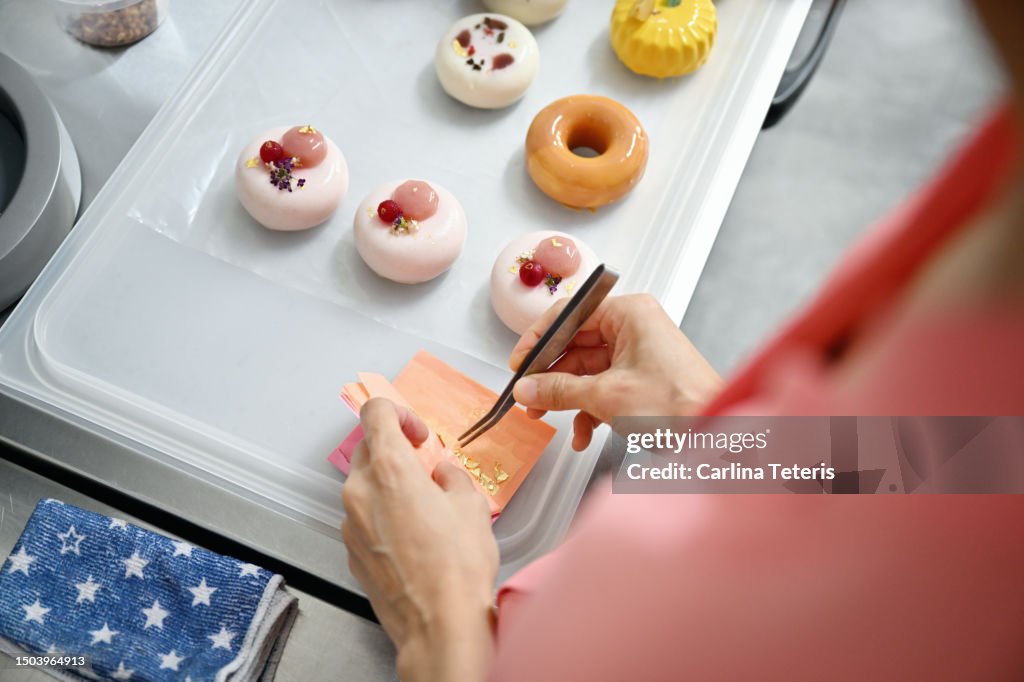 Hands decorating luxury pastries