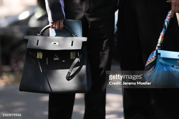 Kiwi Lee is seen wearing a feather blue leather Hermes bag with a scarf, black suit wide leg pants and Jun Chiu is seen wearing a black Hermes Kelly...