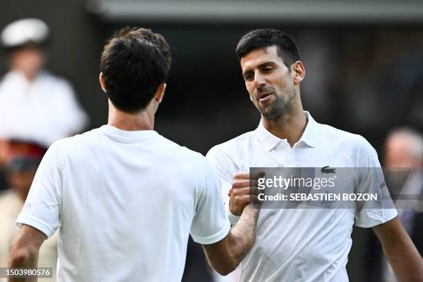 Serbia's Novak Djokovic shakes hands with Australia's Jordan Thompson after winning their men's singles tennis match on the third day of the 2023...