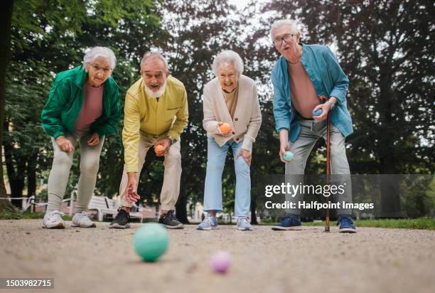 senior friends playing pétanque. - longevità foto e immagini stock