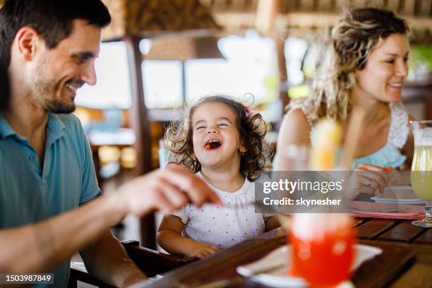 happy girl enjoying with her parents during lunch in a restaurant. - family eating stock pictures, royalty-free photos & images