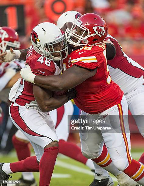 Running back Alfonso Smith of the Arizona Cardinals is tackled by defensive tackle Anthony Toribio of the Kansas City Chiefs at Arrowhead Stadium on...