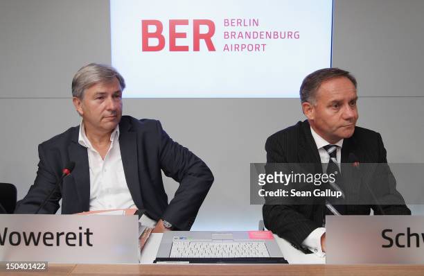 Berlin mayor Klaus Wowereit and Airport head Rainer Schwarz arrive to give a press conference following a meeting of the Governing Board of the new...