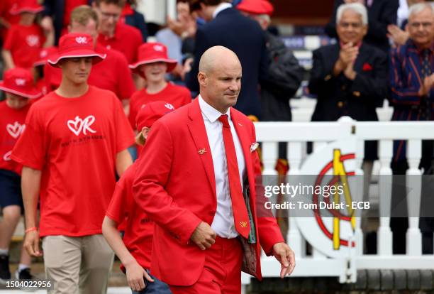 Andrew Strauss and families supported by the Ruth Strauss Foundation after losing a partner and/or parent to cancer enter the field of play to help...