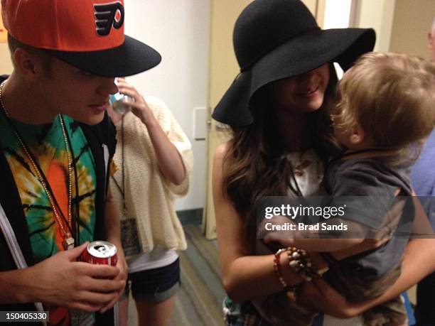 Justin Bieber and Selena Gomez relax backstage at a Phish concert on August 15, 2012 in Long Beach, California. (Photo by Brad Sands/FilmMagic