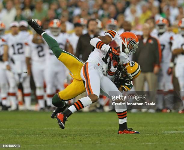 Tramon Williams of the Green Bay Packers tackles Joshua Cribbs of the Cleveland Browns during a preseason game at Lambeau Field on August 16, 2012 in...
